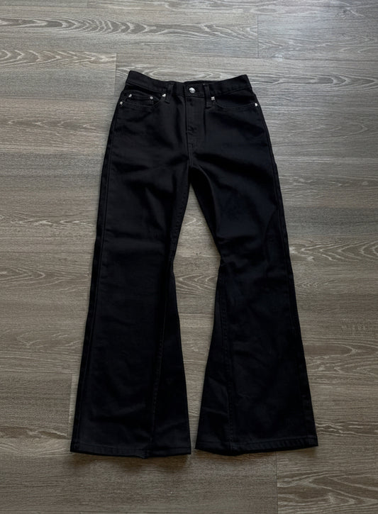 WithoutSaint studded flared denim jeans shown in full view, featuring metallic studs along the flared leg openings.