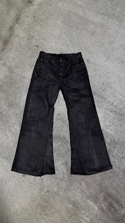 Waxed flared denim jeans by WithoutSaint, showing the fitted waist, flared legs, and textured waxed fabric detail.
